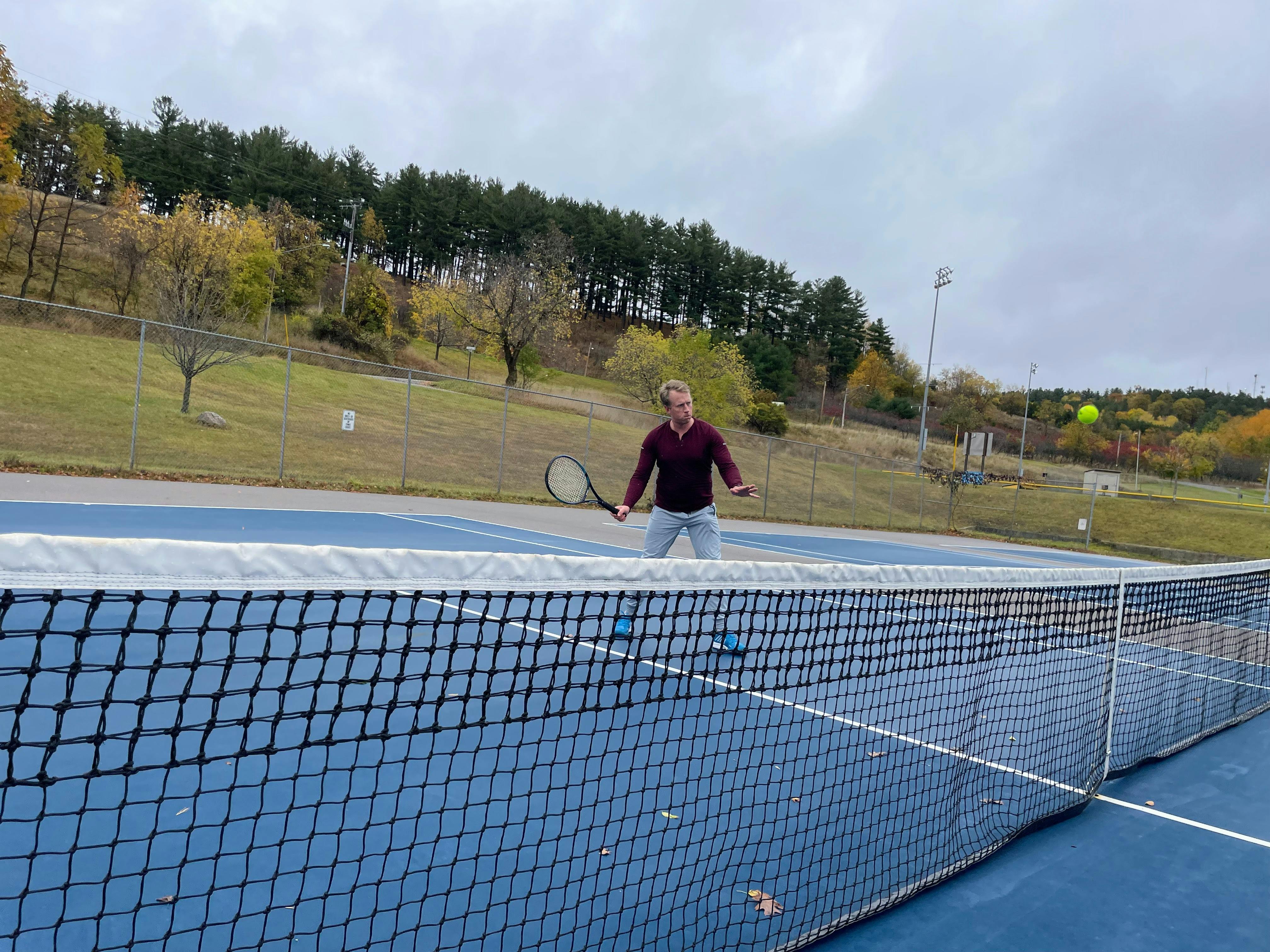 A man using the Yonex EZONE 98 Racquet on the tennis court. 