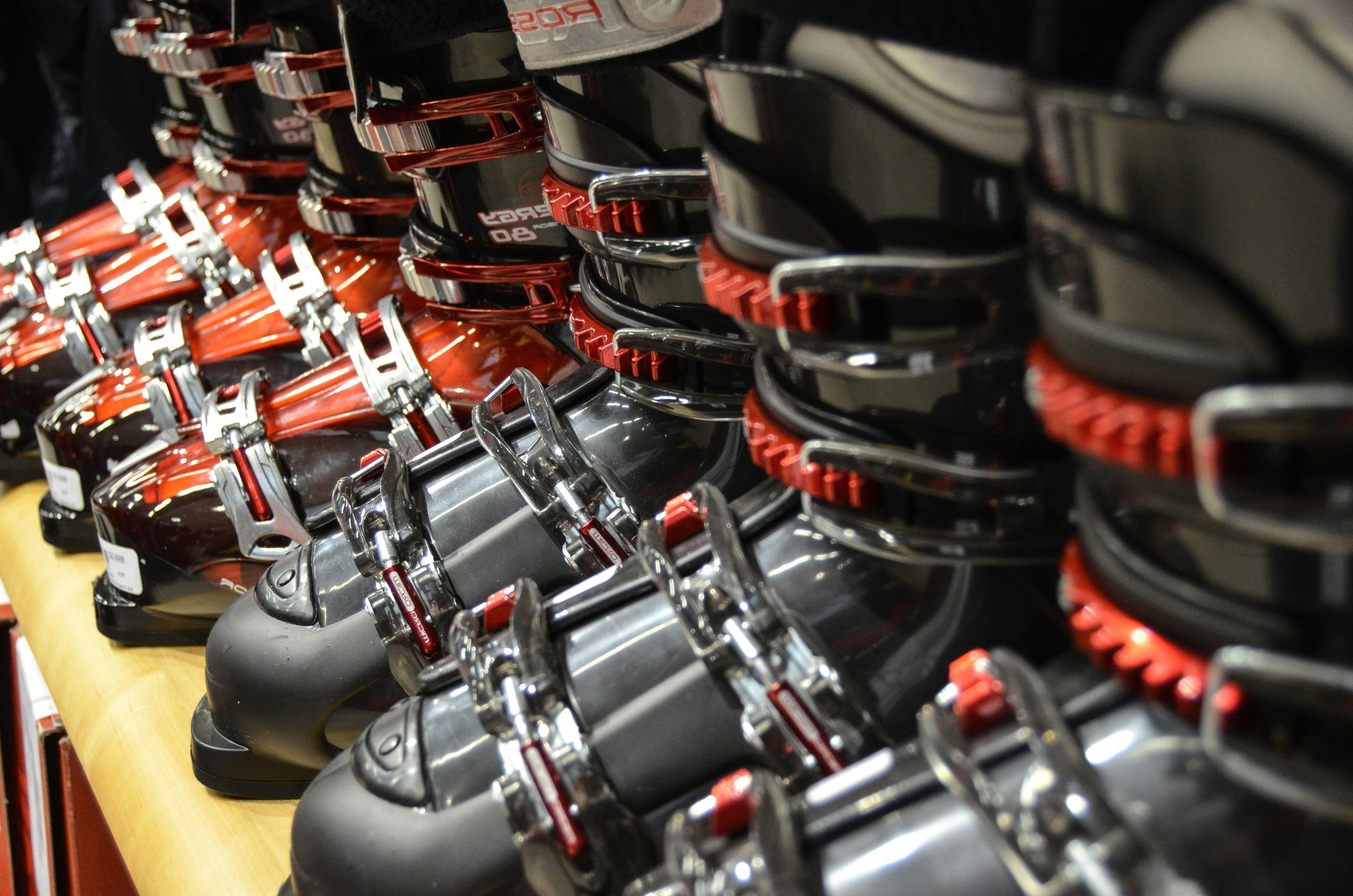 A bunch of ski boots in a row.