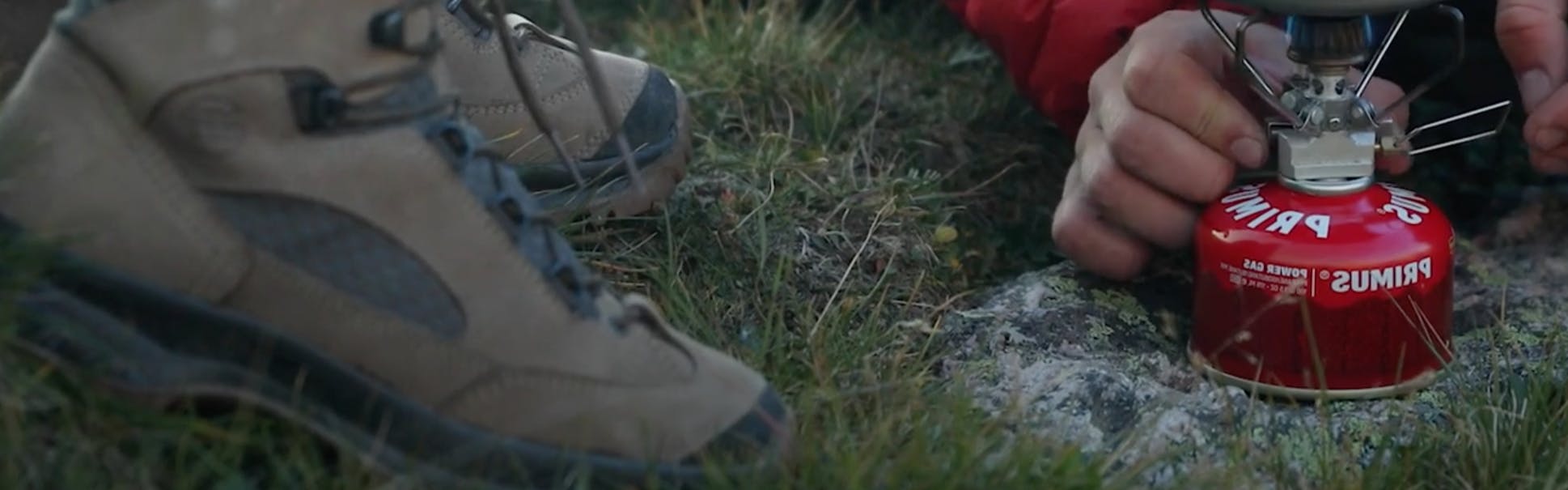 Close up of the Hanwag Banks Lady GTX Hiking Boots and someone turning on a camp stove.