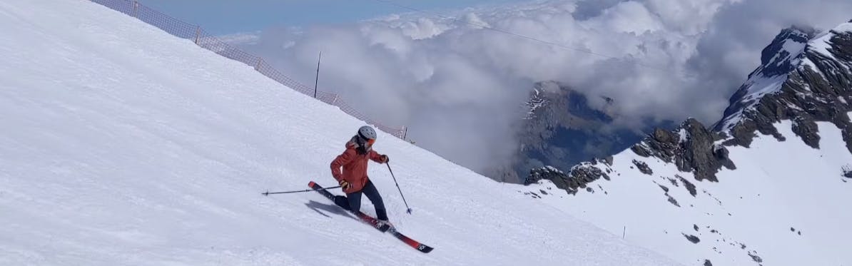 A skier turning down a ski run. 