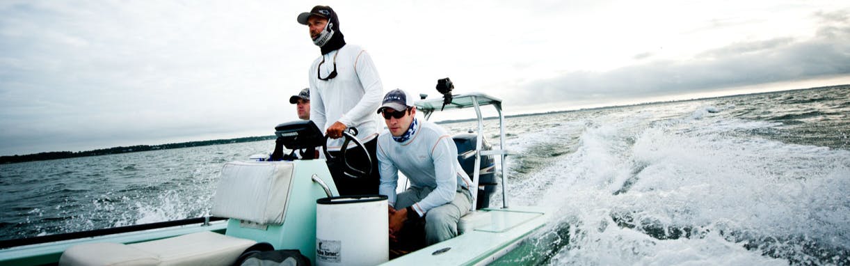 Orvis CEO Simon Perkins and two friends on a speedboat in the ocean