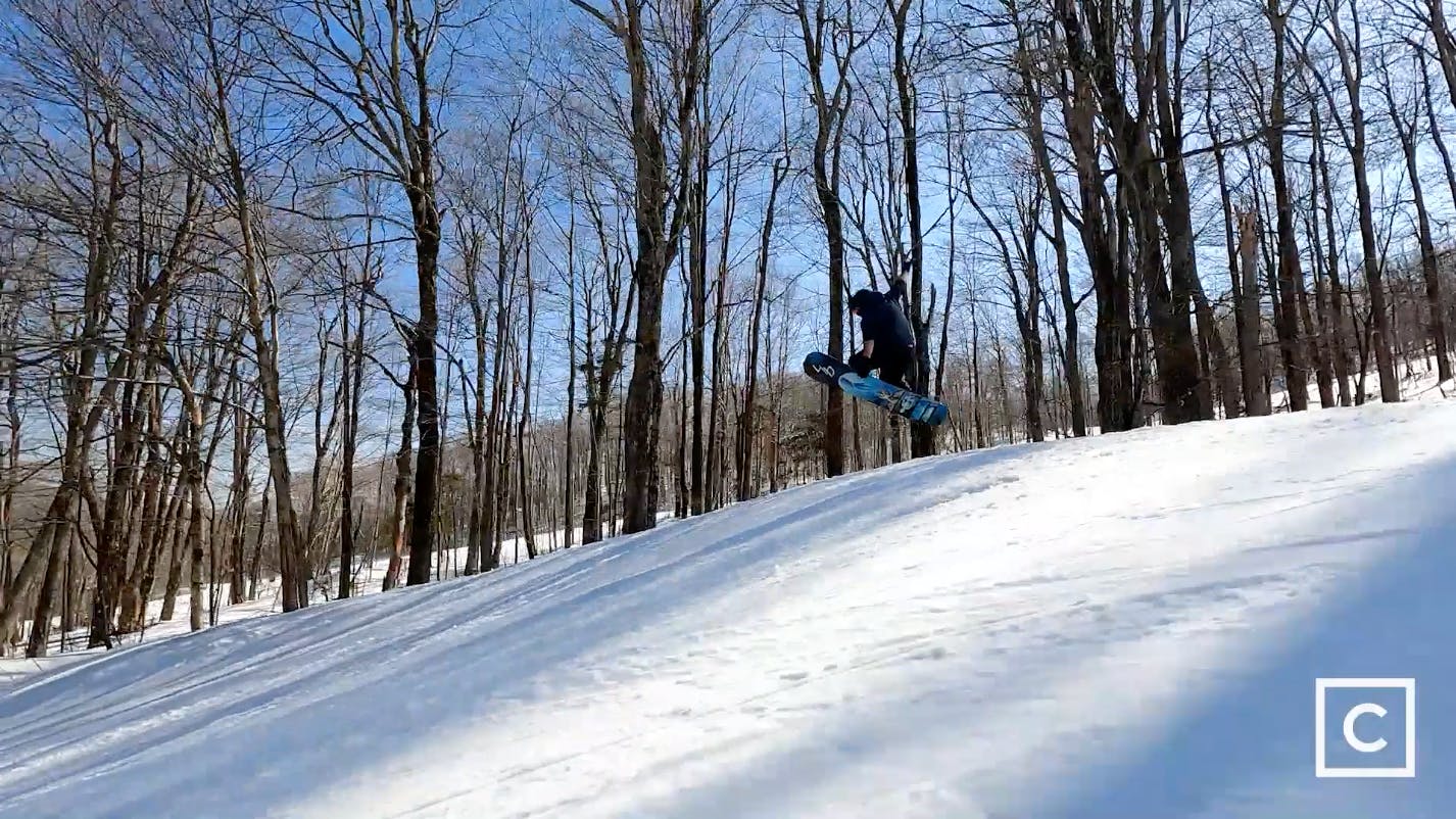 Curated expert Colby Henderson executing a jump with the Lib Tech Golden Orca snowboard