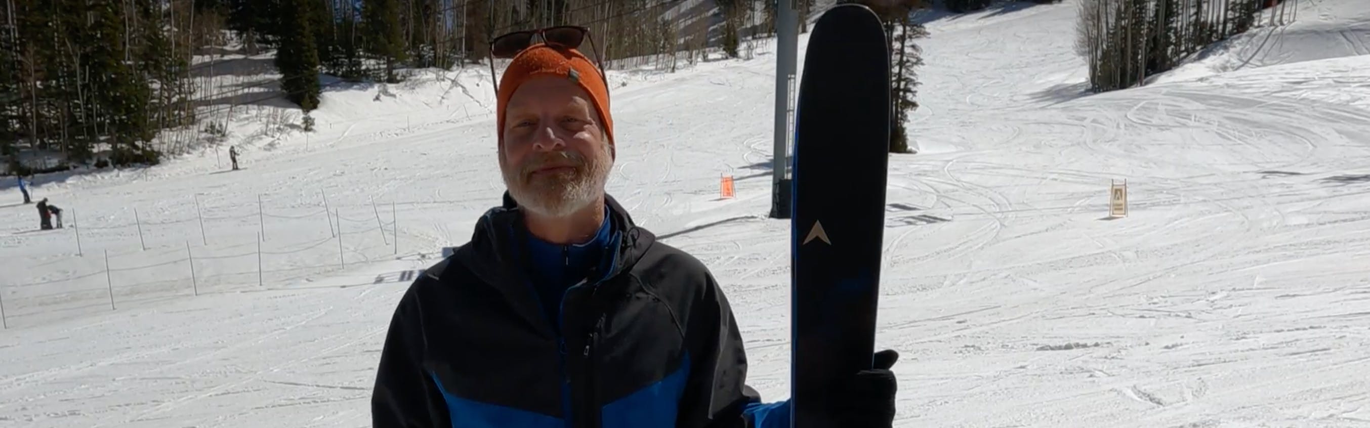 A man holding the 2023 Dynastar M-Pro 90 skis. 