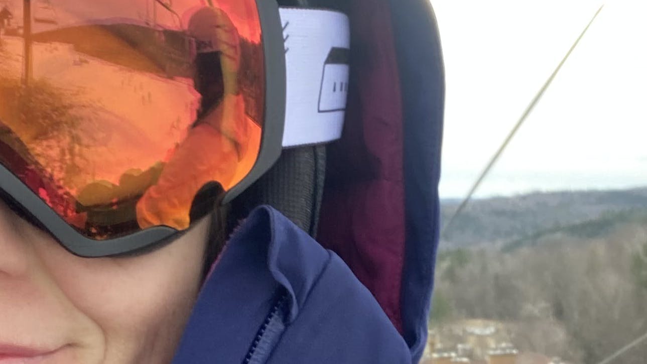 A skier wearing the Anon Logan Wavecel Helmet.
