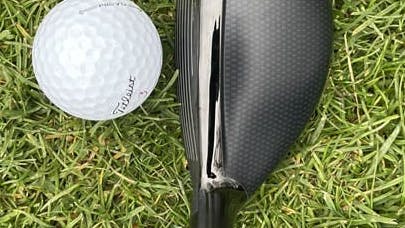 The TaylorMade Stealth 2 Rescue Hybrid in front of a golf ball. 
