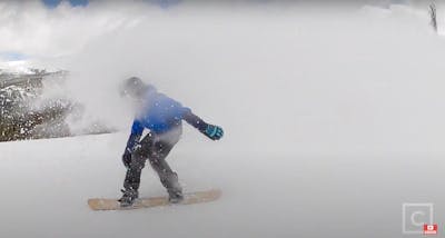 Screenshot from the YouTube video of Bobby Chadderton riding through powder on the 2022 CAPiTA Kazu Kokubo Pro. 