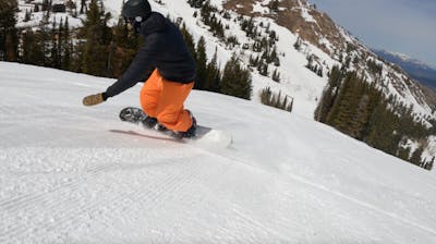 Snowboard Expert Yuri Czmola carving on a groomed run with the 2023 Arbor Element Camber snowboard