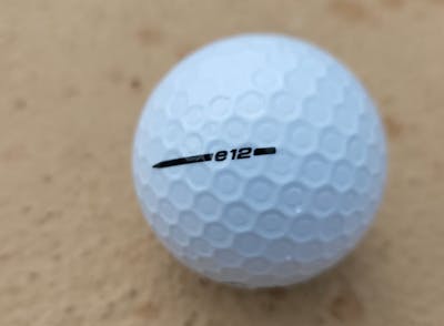 Close up of the Bridgestone 2021 e12 Contact White Golf Ball.