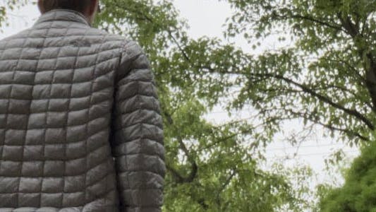 The back view of a man wearing the Thermoball North Face Jacket.
