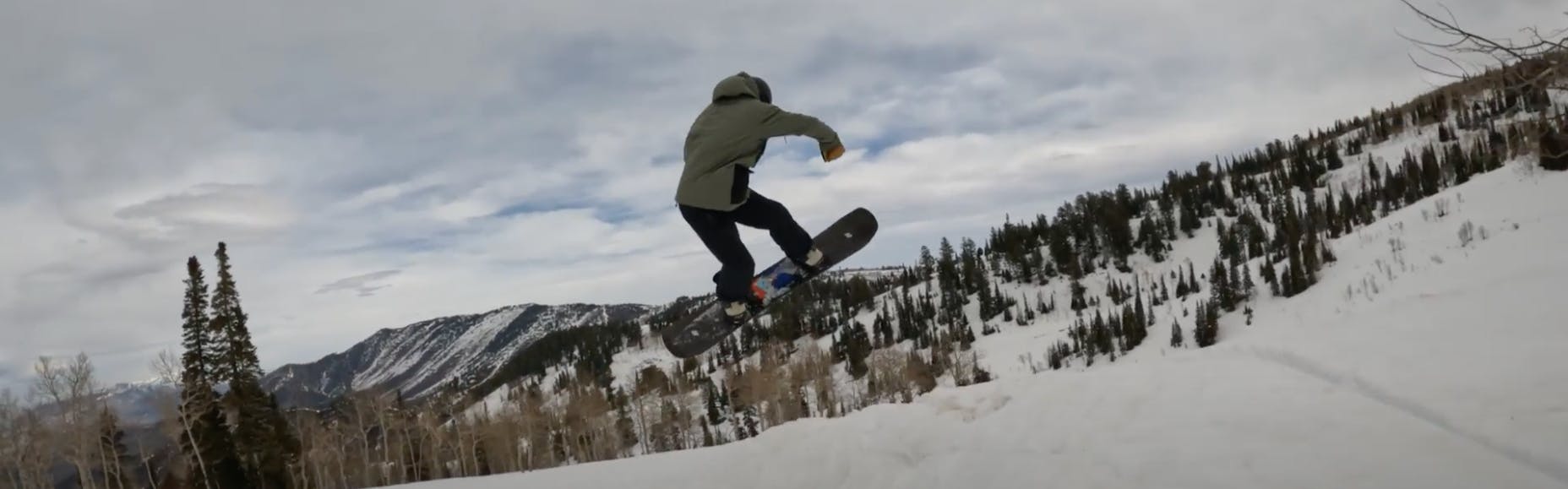 Curated Snowboard Expert Spencer Storck jumping with the 2023 K2 Afterblack snowboard
