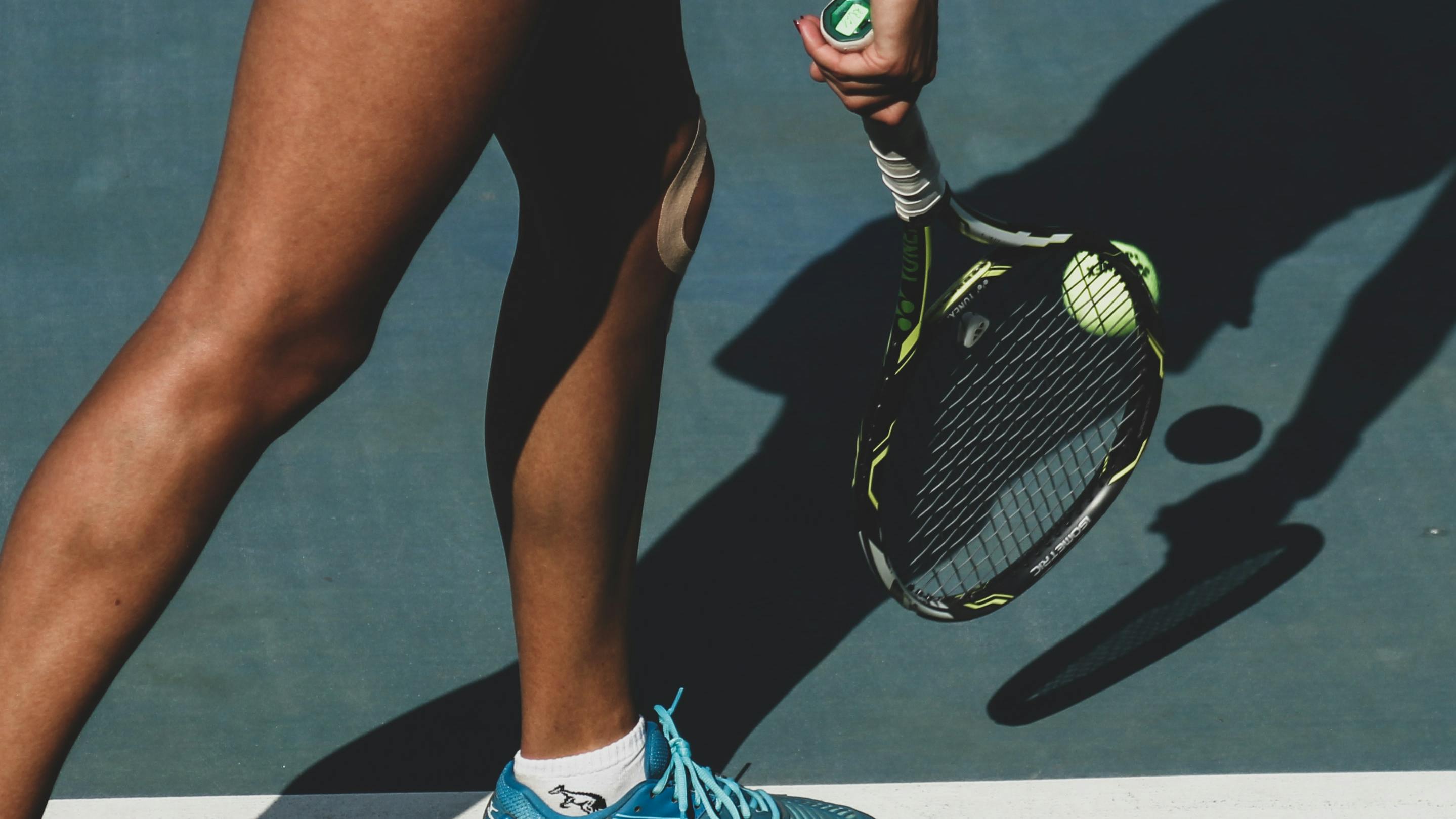A tennis player hitting a ball with a racquet. 