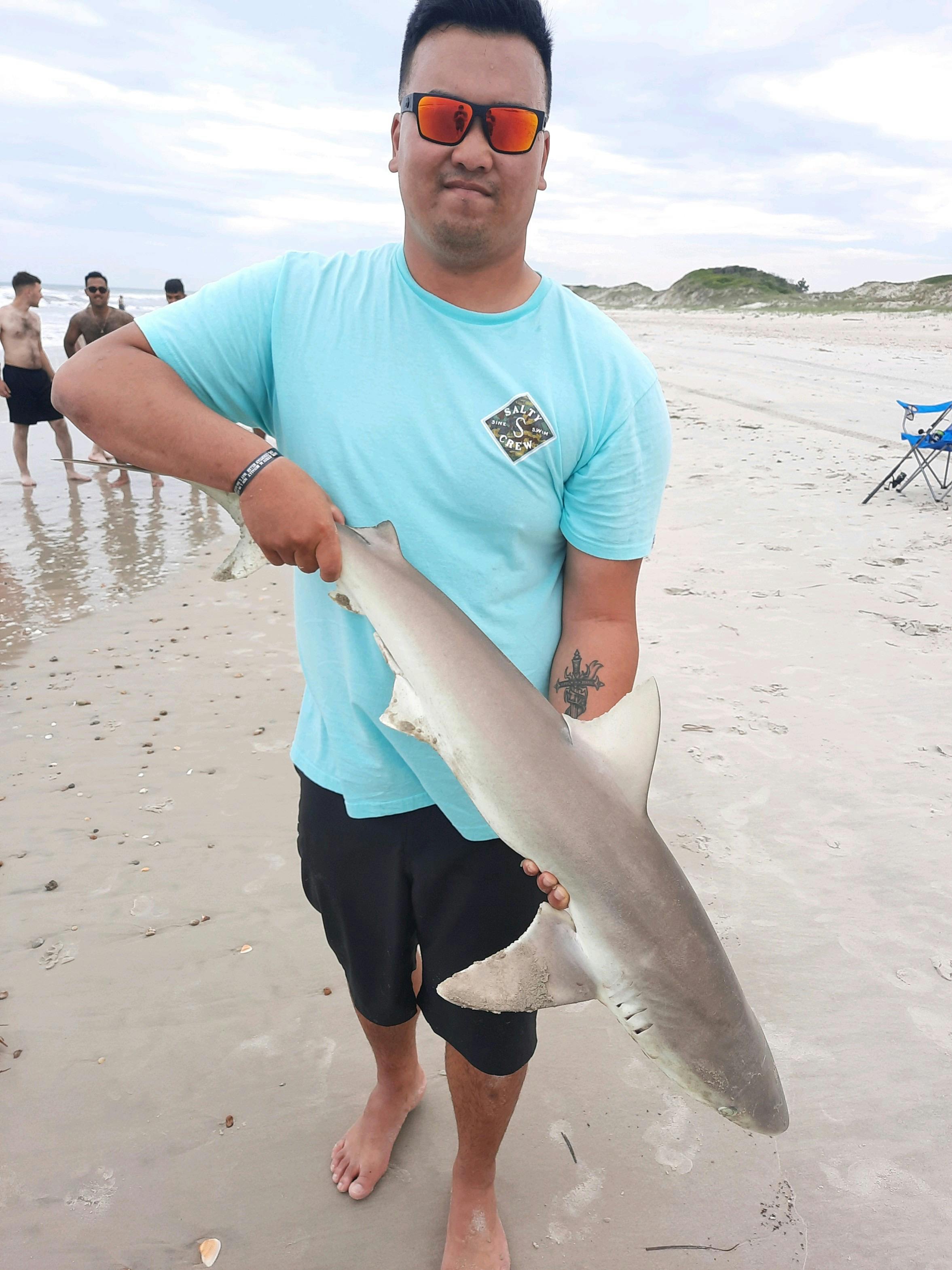A man holding a shark. 