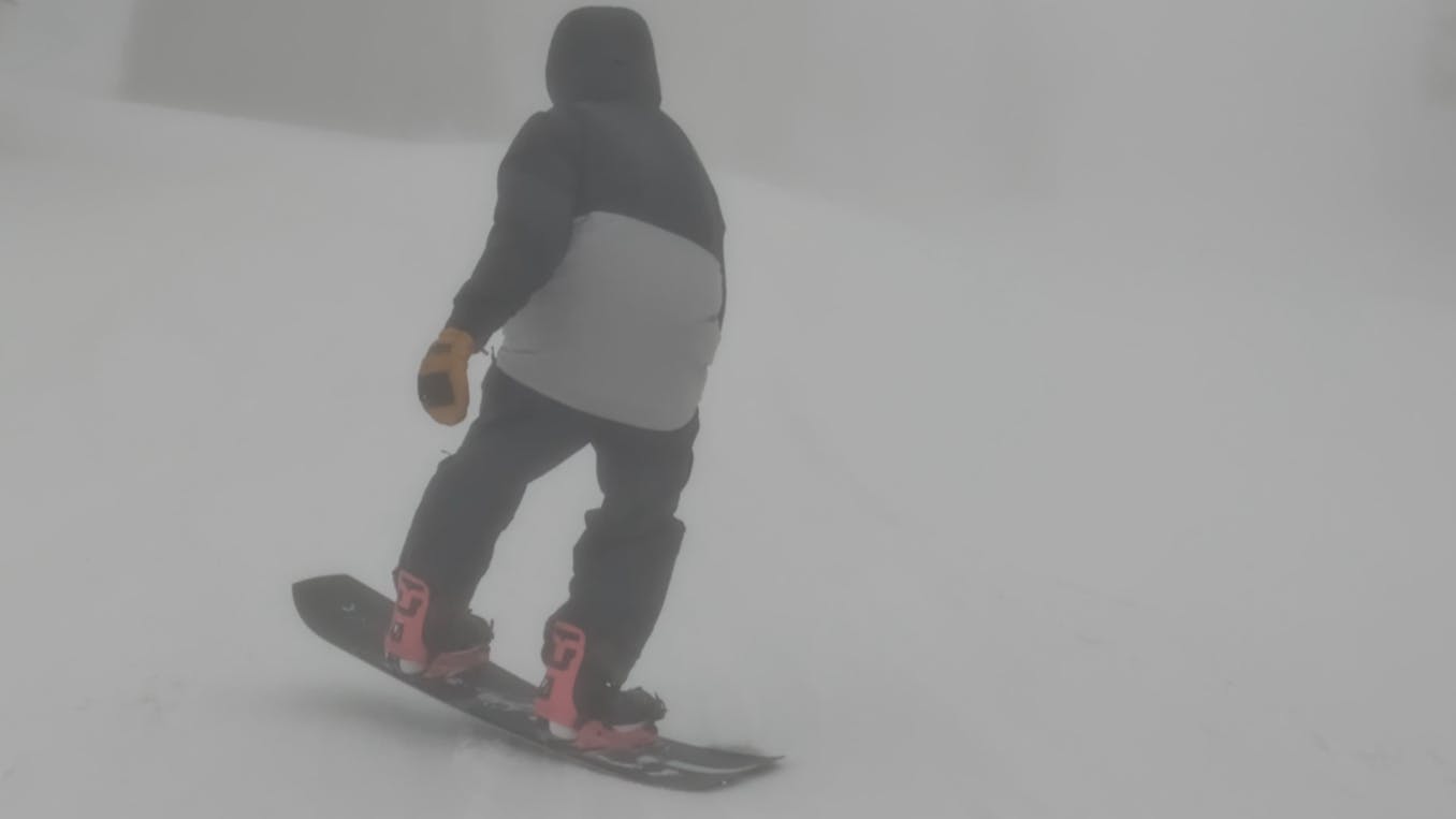 A snowboarder on the  2023 Ride Superpig Snowboard.