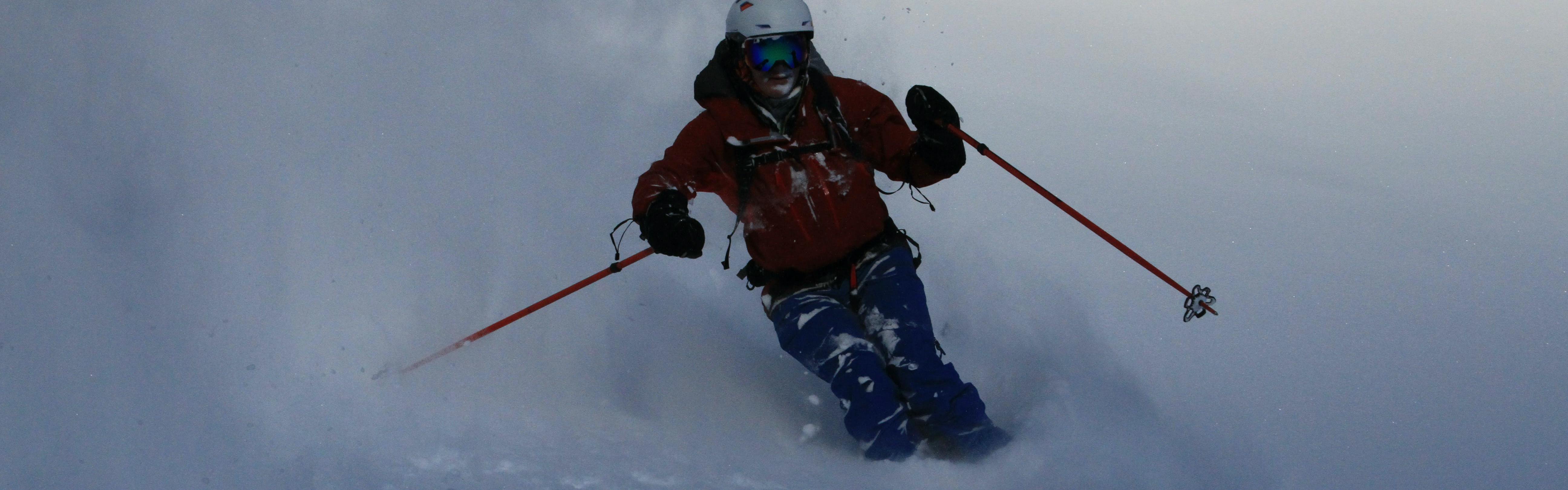 A man powder skiing with the Dynafit Beast AT ski boots. 