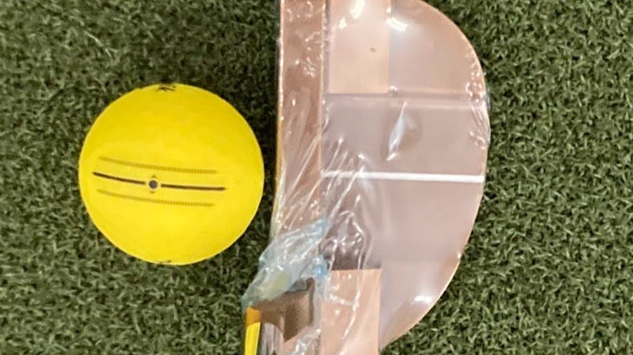 The  Bettinardi Queen B Series QB11 putter in front of a golf ball. 