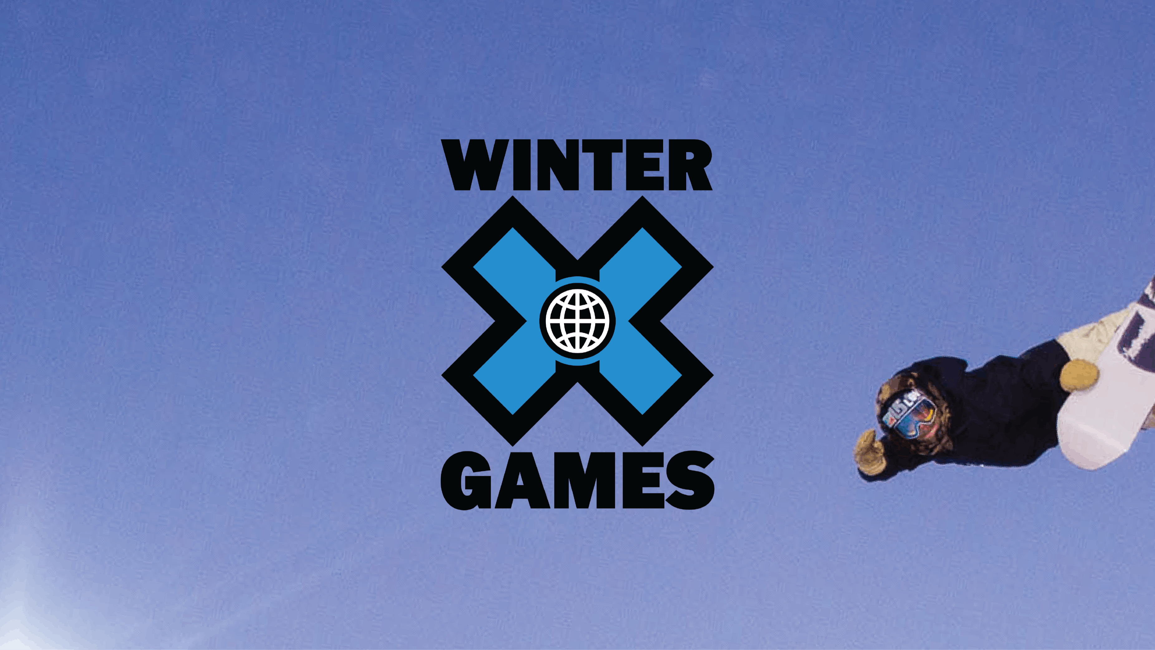 A snowboarder jumps against a blue sky with an added Winter X Games logo on top of the image.