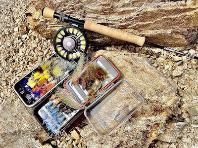 A box of flies and the Sage Foundation Fly Rod.
