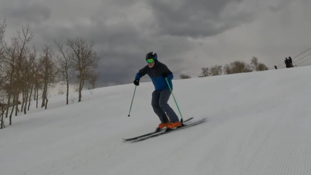 Ski Expert Rob G. skiing on the 2023 K2 Mindbender 99 Ti skis on a cloudy day