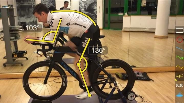 A man on a bike with measurements indicating its a bike fitting.