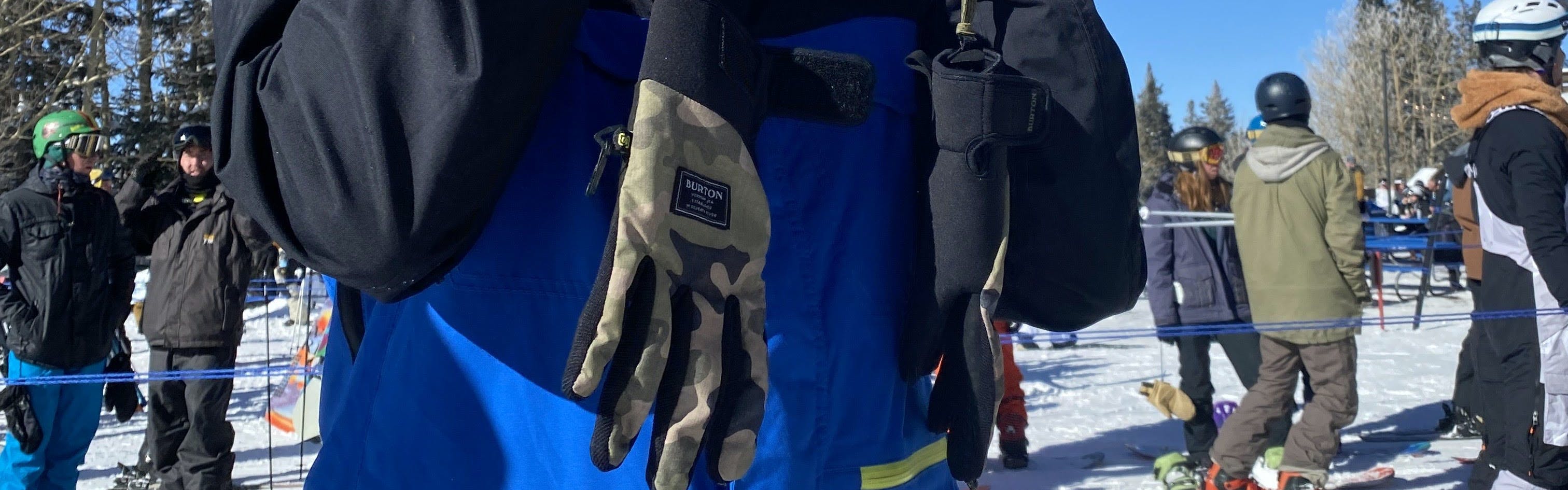 A snowboarder holding the Burton Park Glove by the durable leashes.