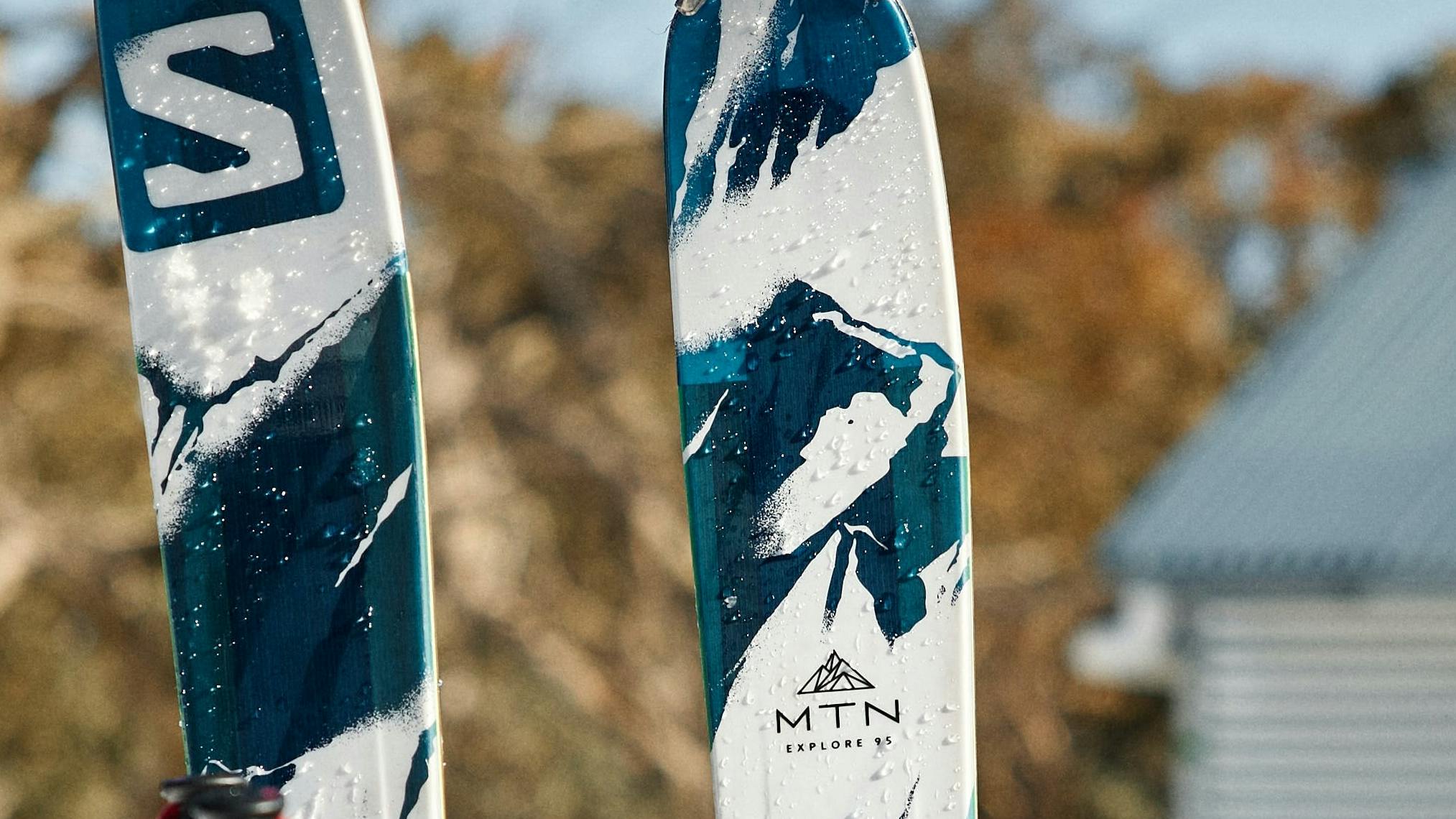 A pair of Salomon skis sticking in the snow. 