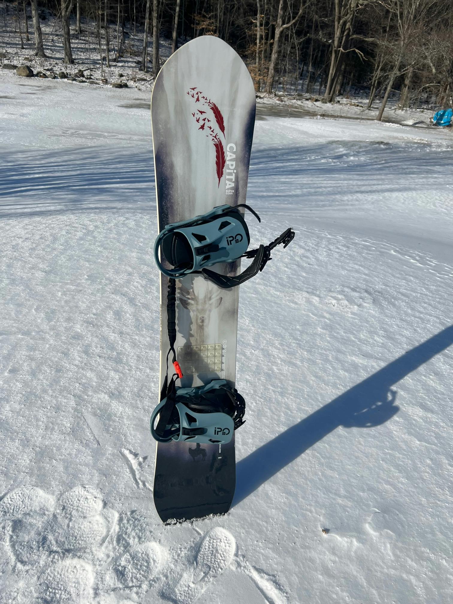 The  Now Ipo Snowboard Bindings on a snowboard.