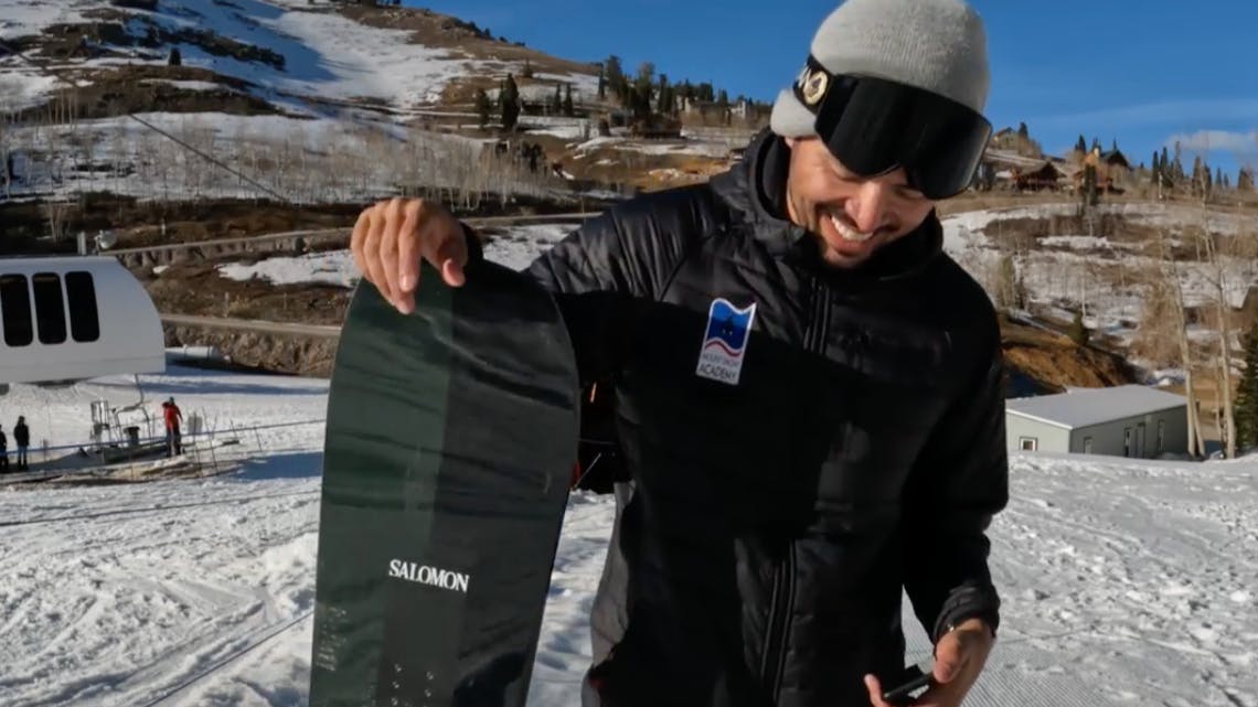 Snowboard Expert Yuri Czmola standing with the 2023 Salomon Assassin Pro snowboard