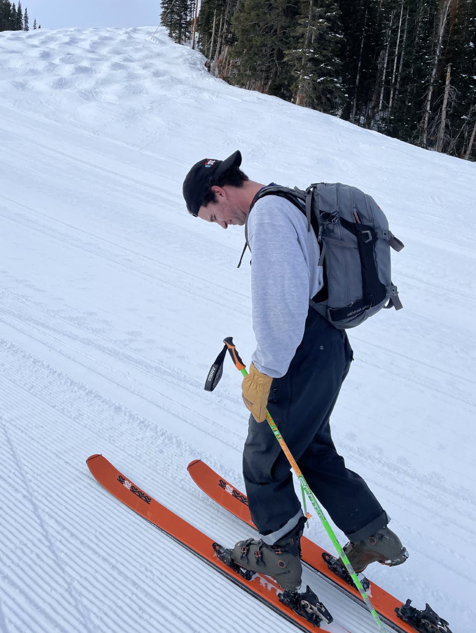 A backcountry skier putting his boot in his ski. 