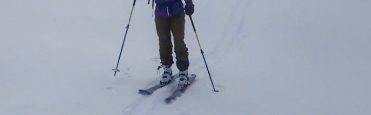 A skier skis on the DPS Zelda Alchemist 106 skis. 