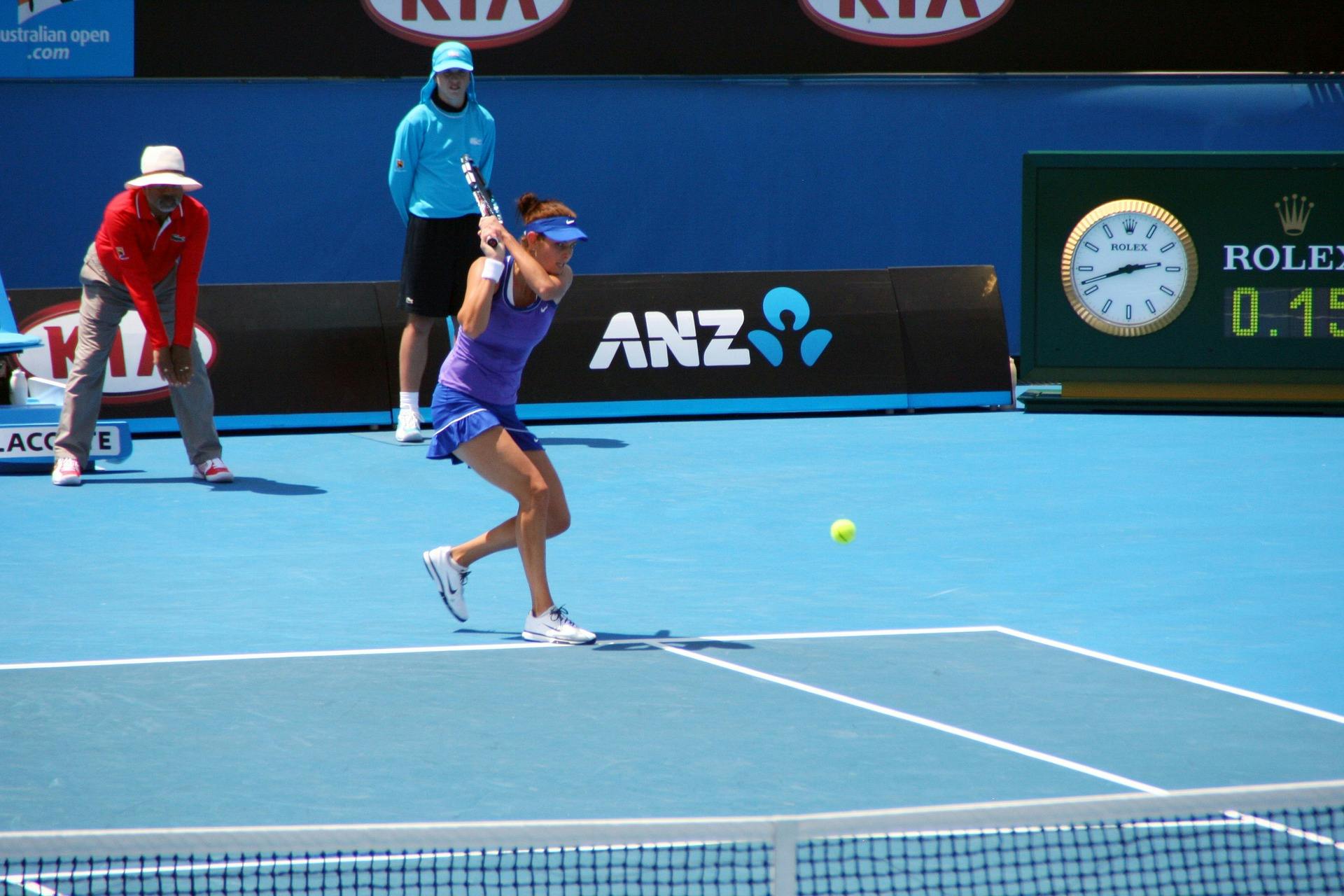 Woman hitting tennis ball at Australian Open