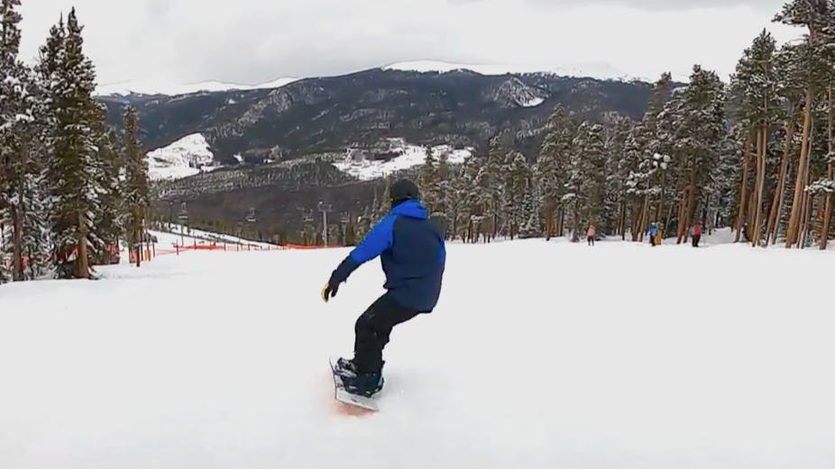 Man riding the Never Summer Harpoon Snowboard