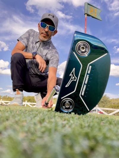 Man holds the Mizuno M.Craft Type III Putter on the ground.