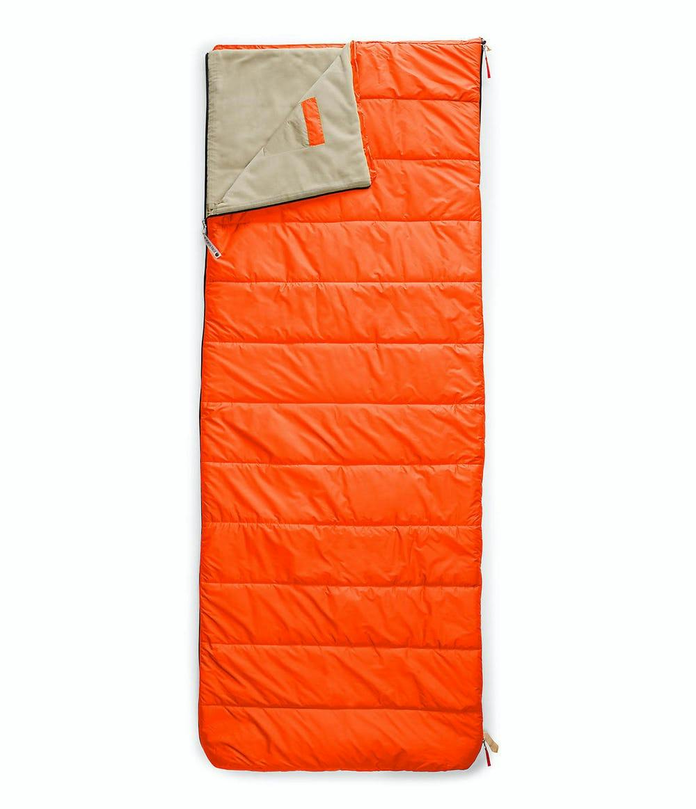 An orange rectangular sleeping bag with tan lining