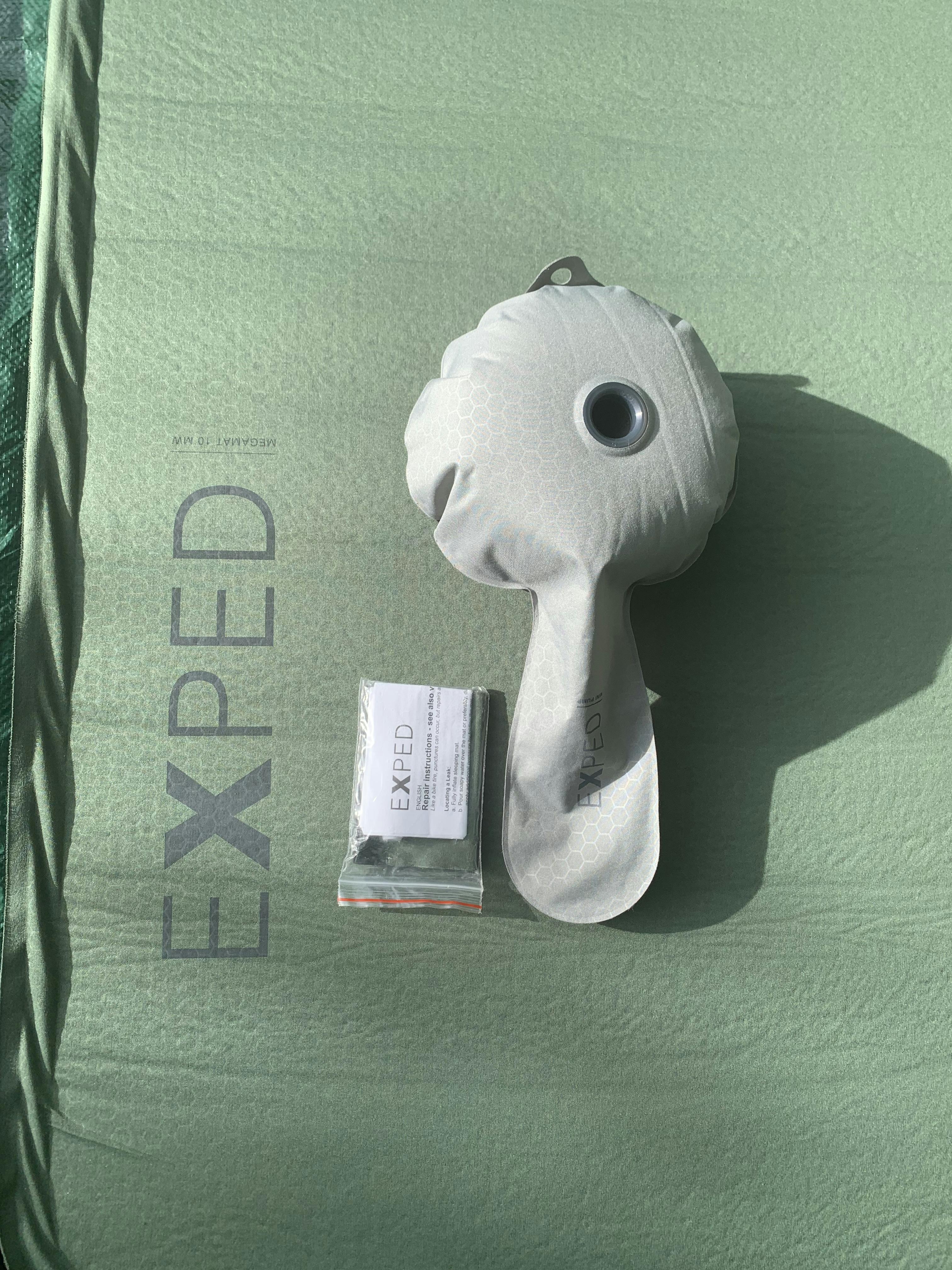 Close up view of the pump and repair kit that comes with the ExPed MegaMat sleeping pad. 