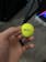A yellow golf ball with Srixon Q-Star Tour written on it. The ball is held in a hand