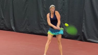A tennis player using the Solinco Blackout 300 XTD Unstrung Tennis Racquet.