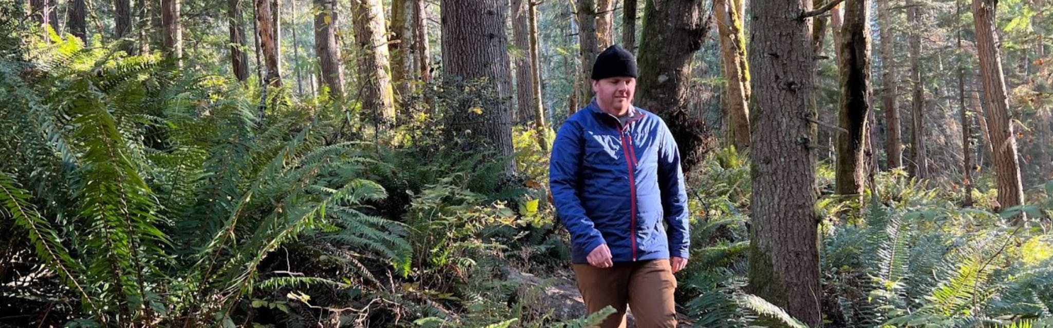 A man walking through the forest in the Spyder Glissade Jacket.