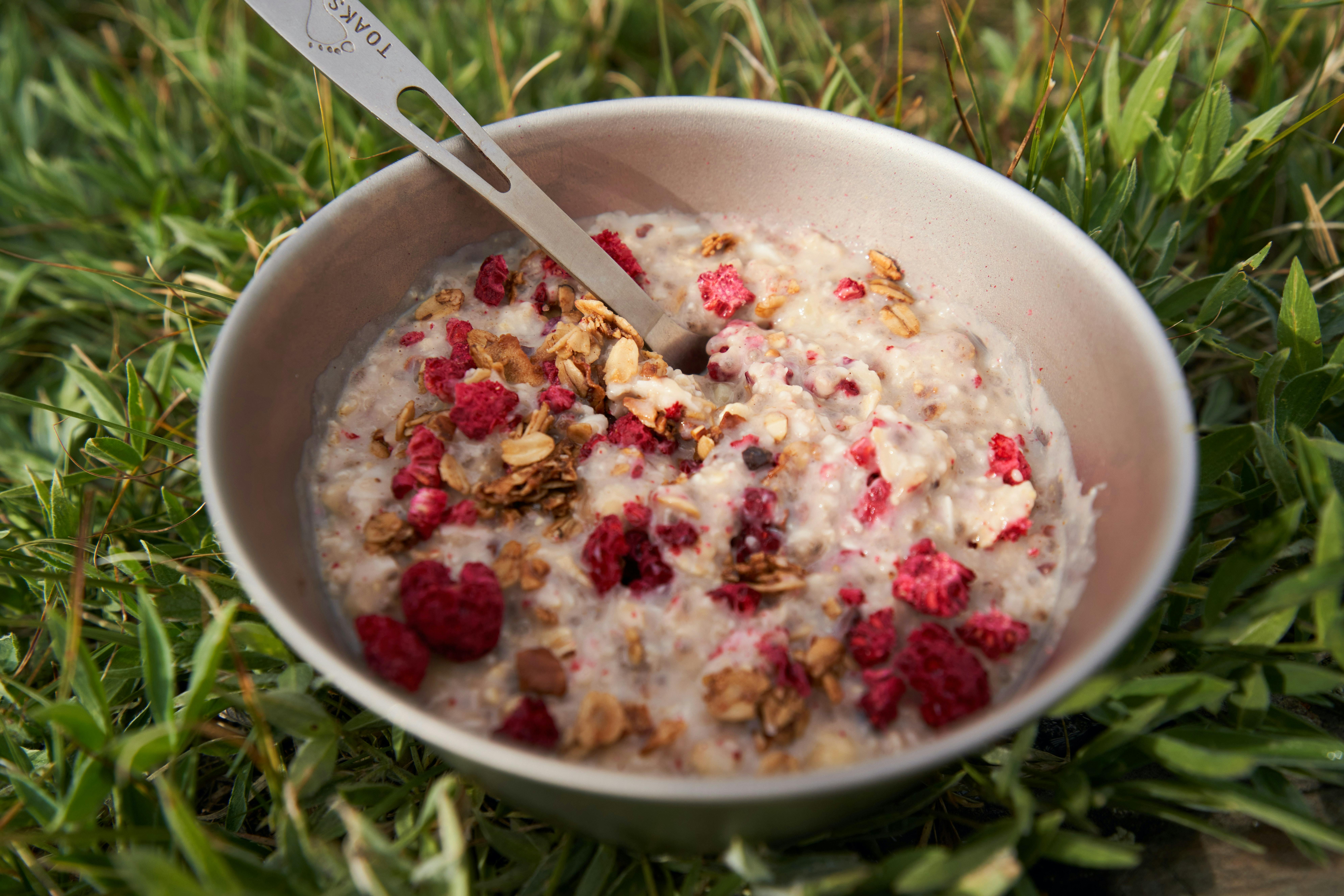 Some oatmeal with granola and berries in it. 