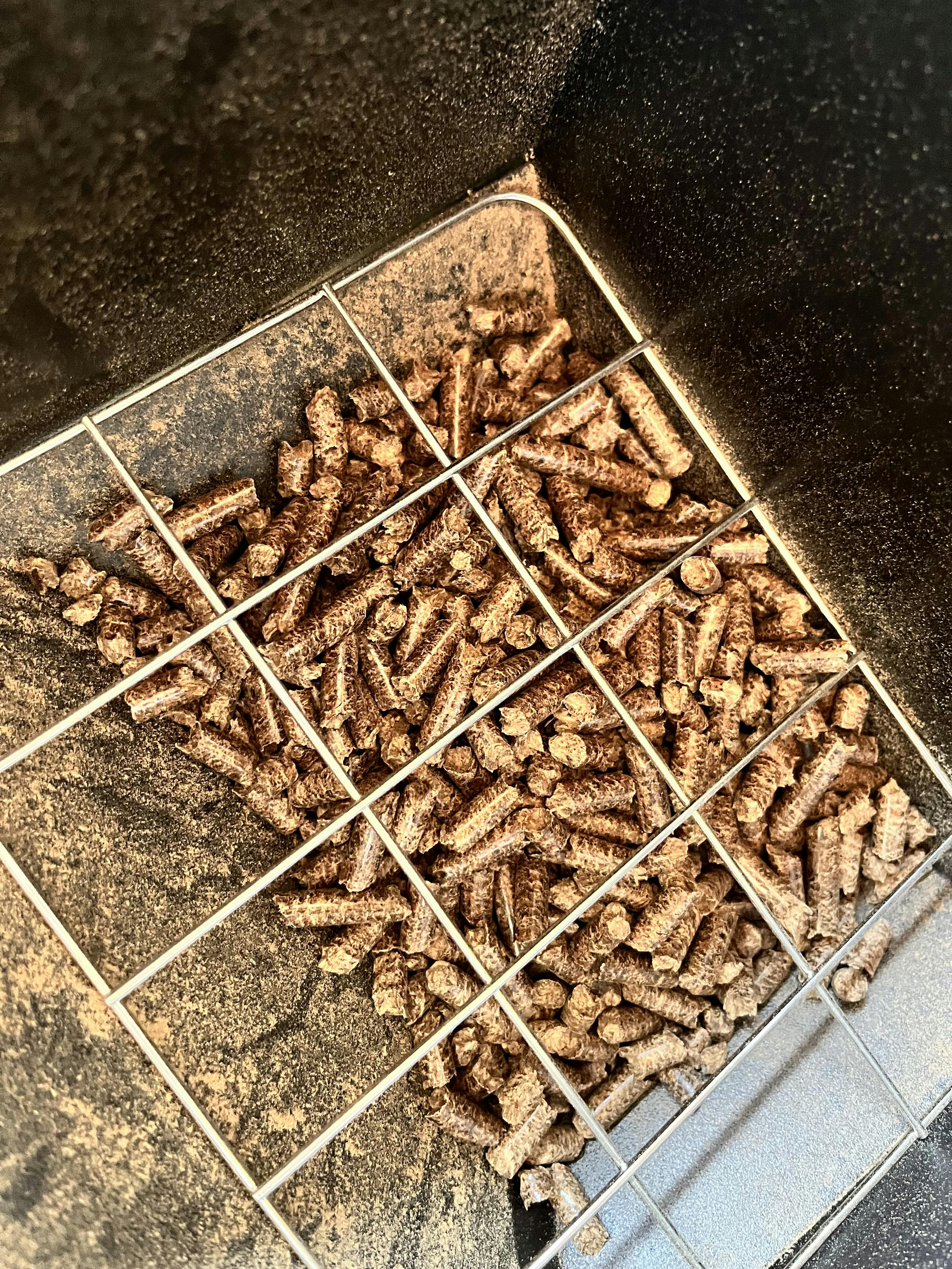Hopper filled with pellets on a pellet grill.
