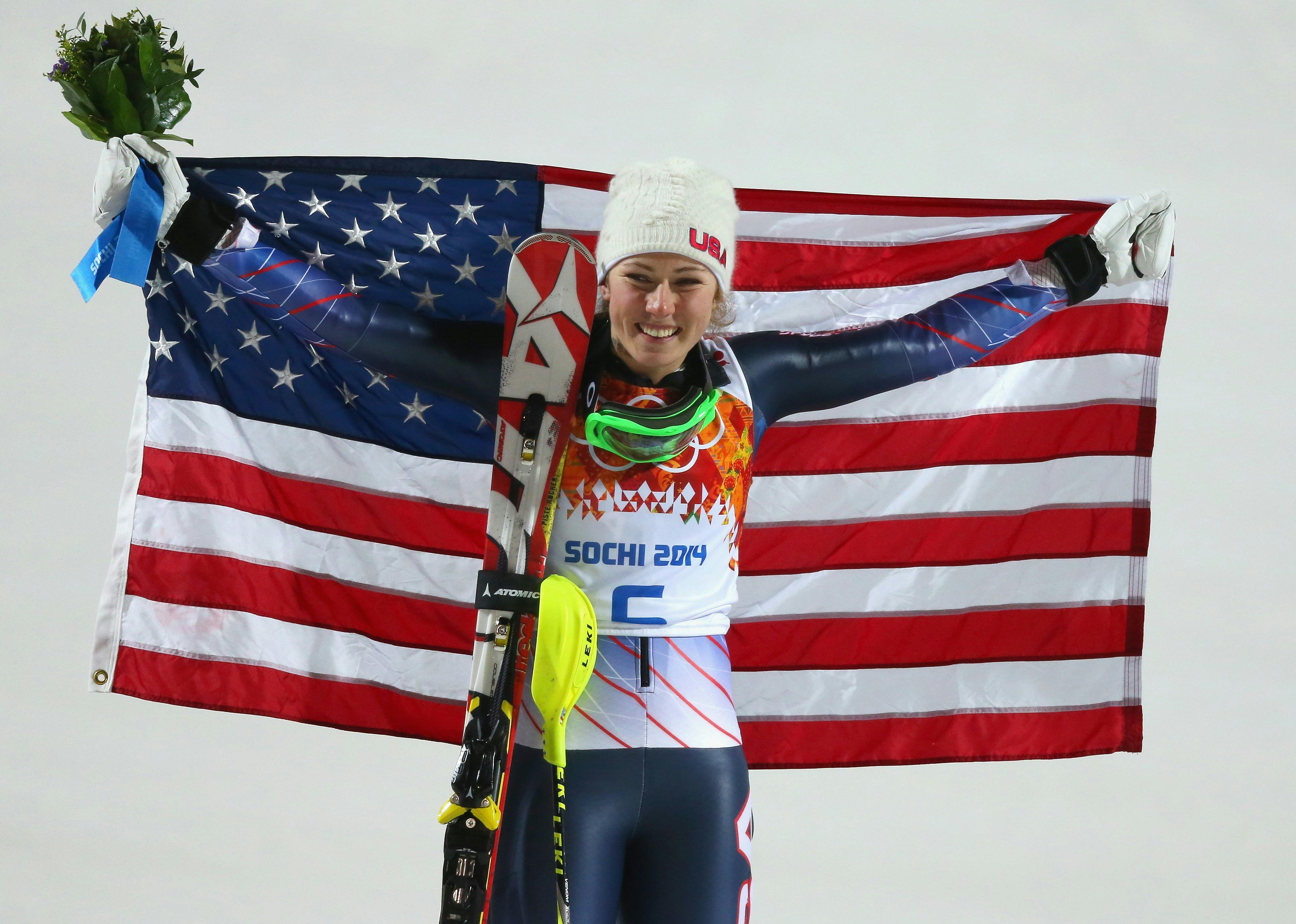 Mikaela Shiffrin holding up an American flag