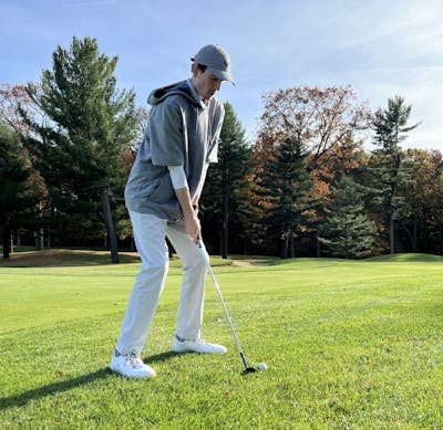 A golfer using the Mizuno T22 Satin Chrome Wedge.