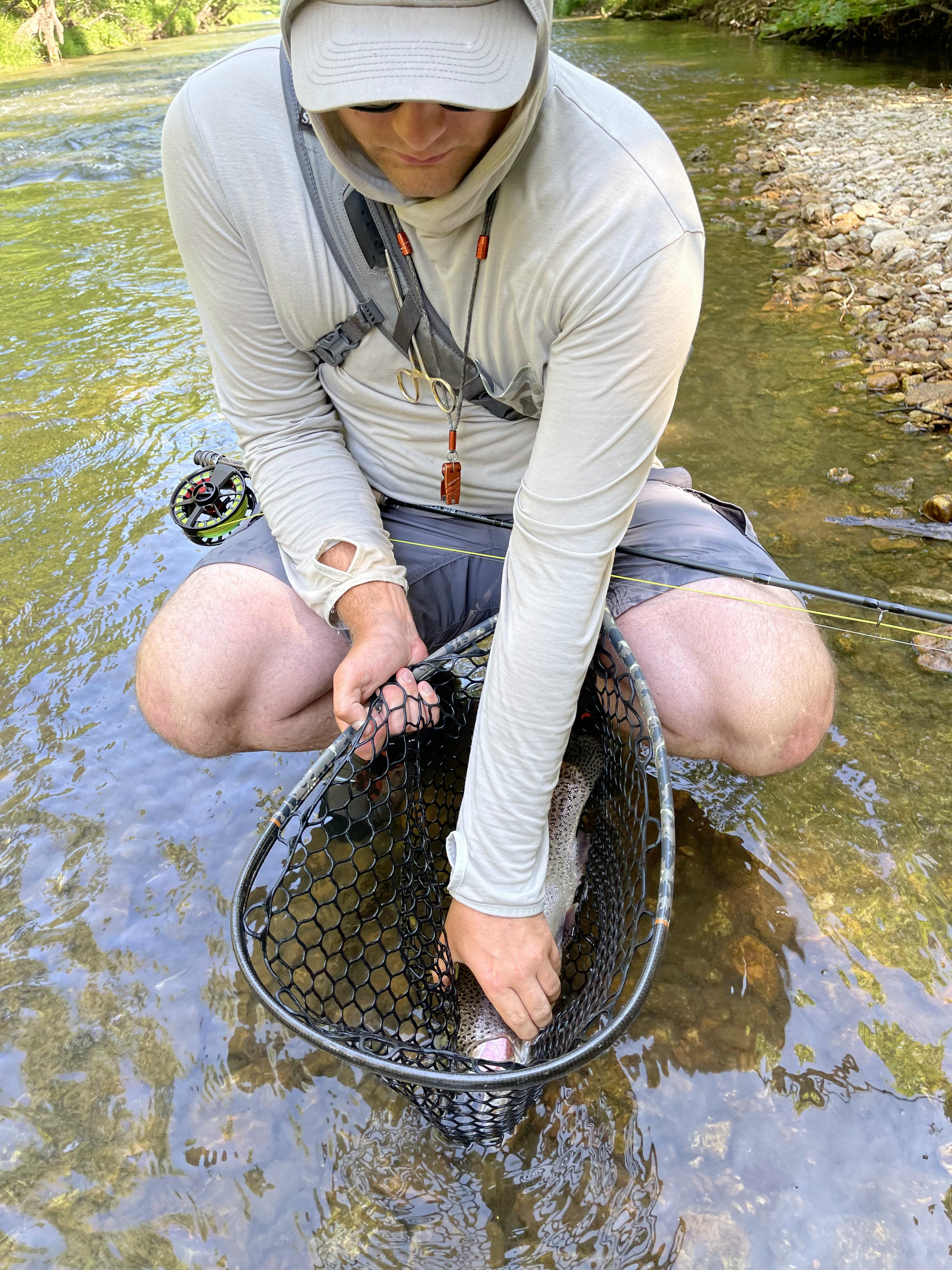 A fisherman with the Lamson Speedster S Fly Reel.