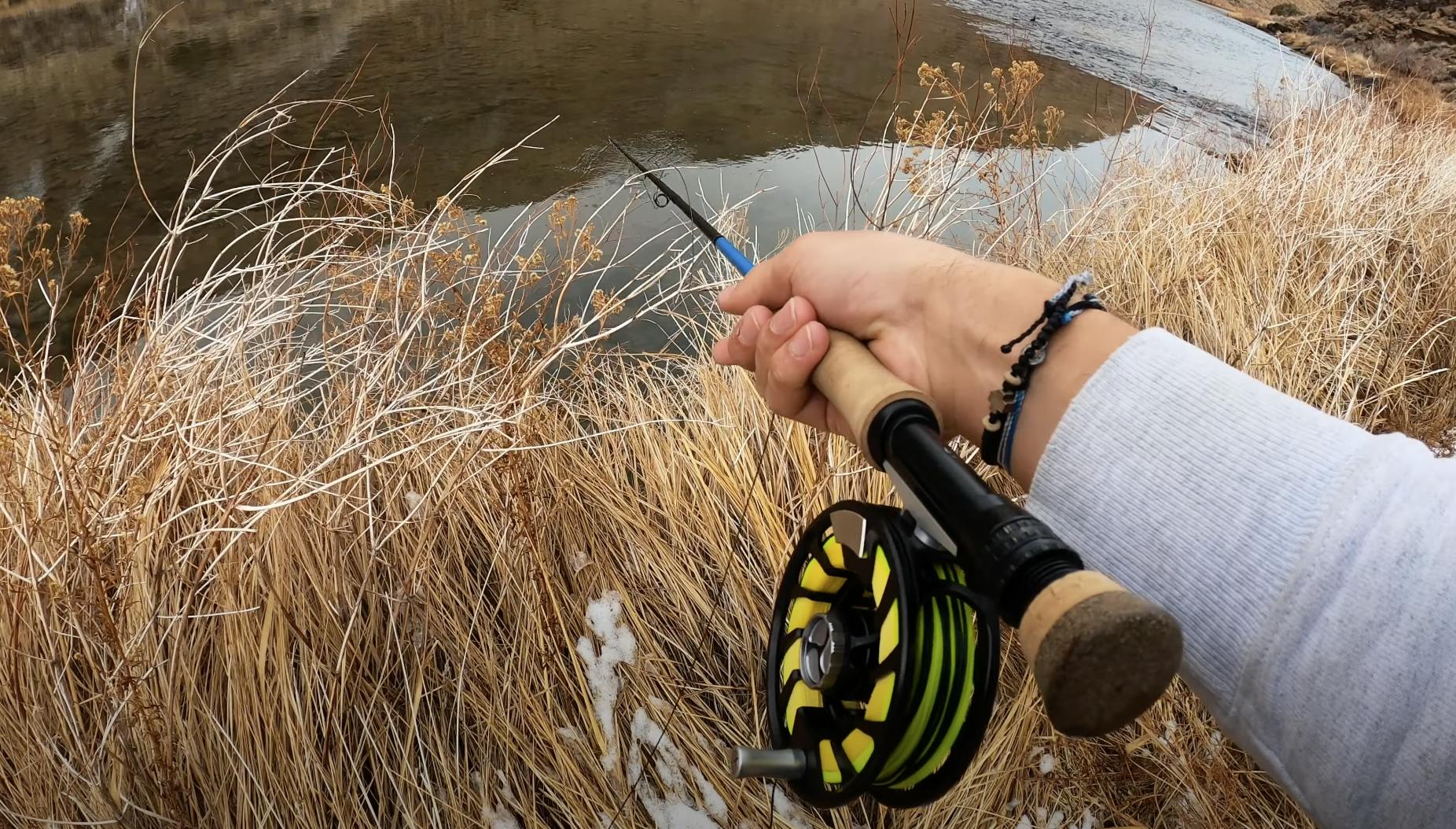 The Orvis Pro Depth Charge 3D Smooth Fly Line on a fly fishing rod and reel with a river in the background. 
