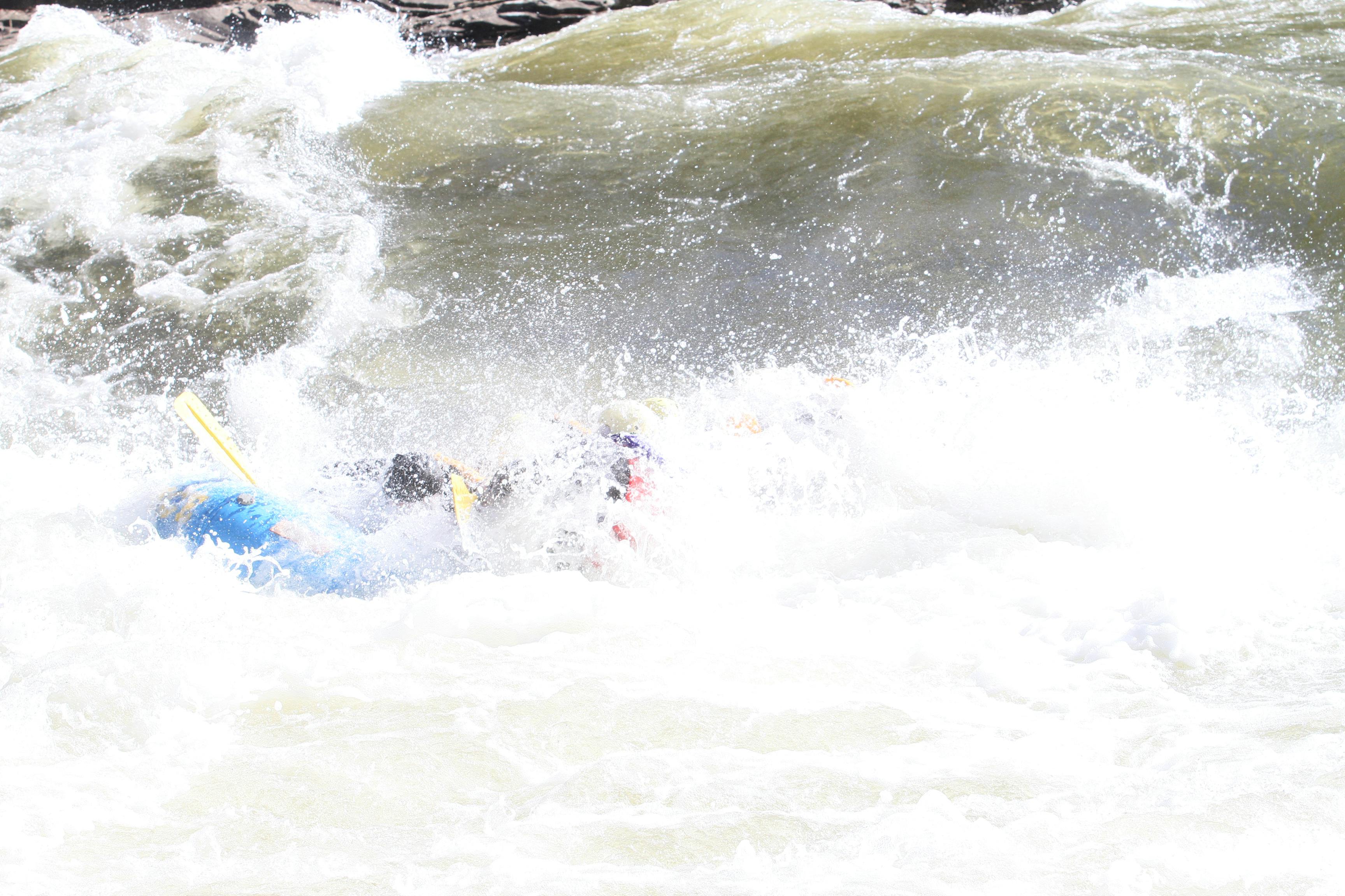 Whitewater rafters fall into the water