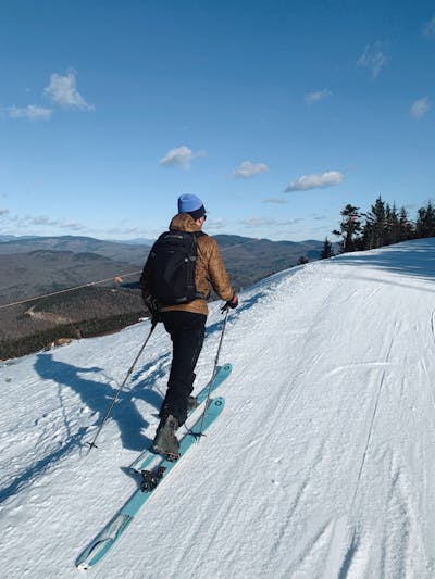 A person ski touring using the Tecnica Cochise 120 DYN Ski Boots.