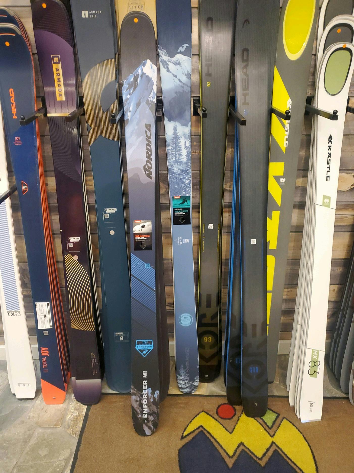 Skis lying against a wall.