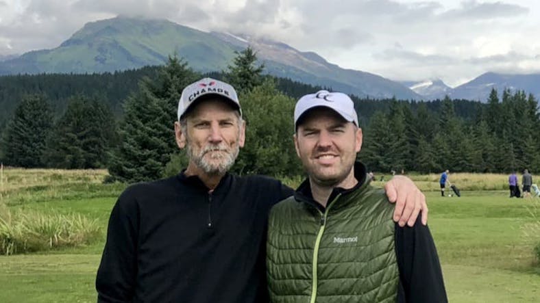 The author and his father in Juneau, Alaska at Mendenhall Golf Course with a glacier in the background.