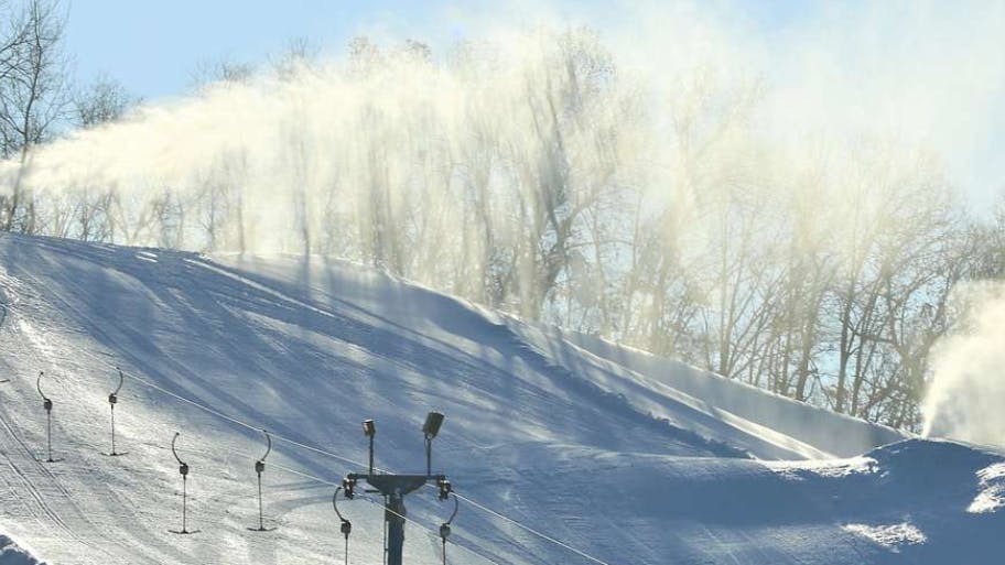 A snow-making machine drops man-made snow on one of the slopes Jan. 9, 2019, at Whitetail Ridge Ski Area at Fort McCoy, Wis.