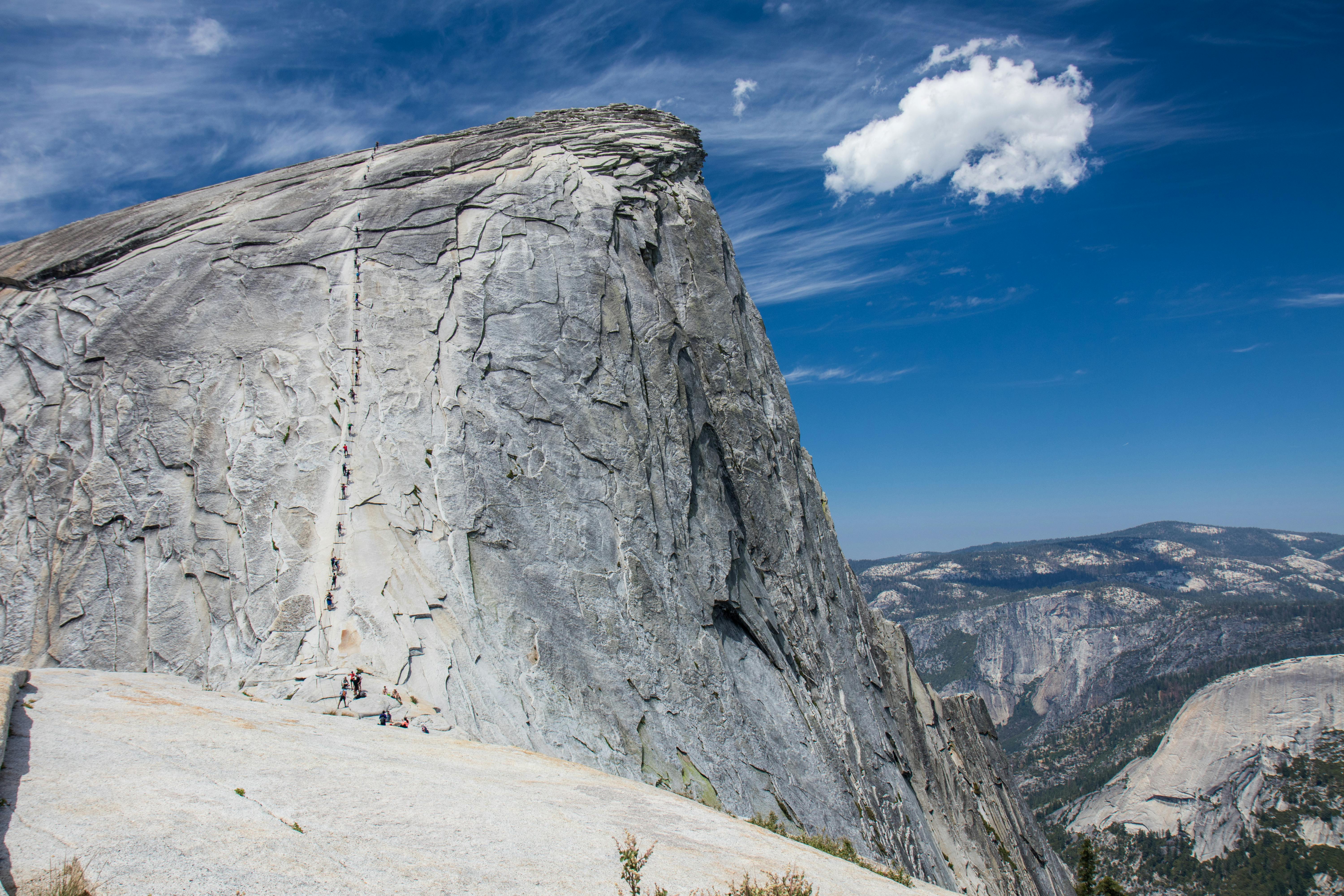 A line of hikers making their way up Half Dome in Yosemite National Park