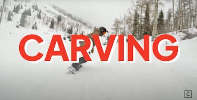 The words "carving" overlayed on an image of a man snowboarding. 